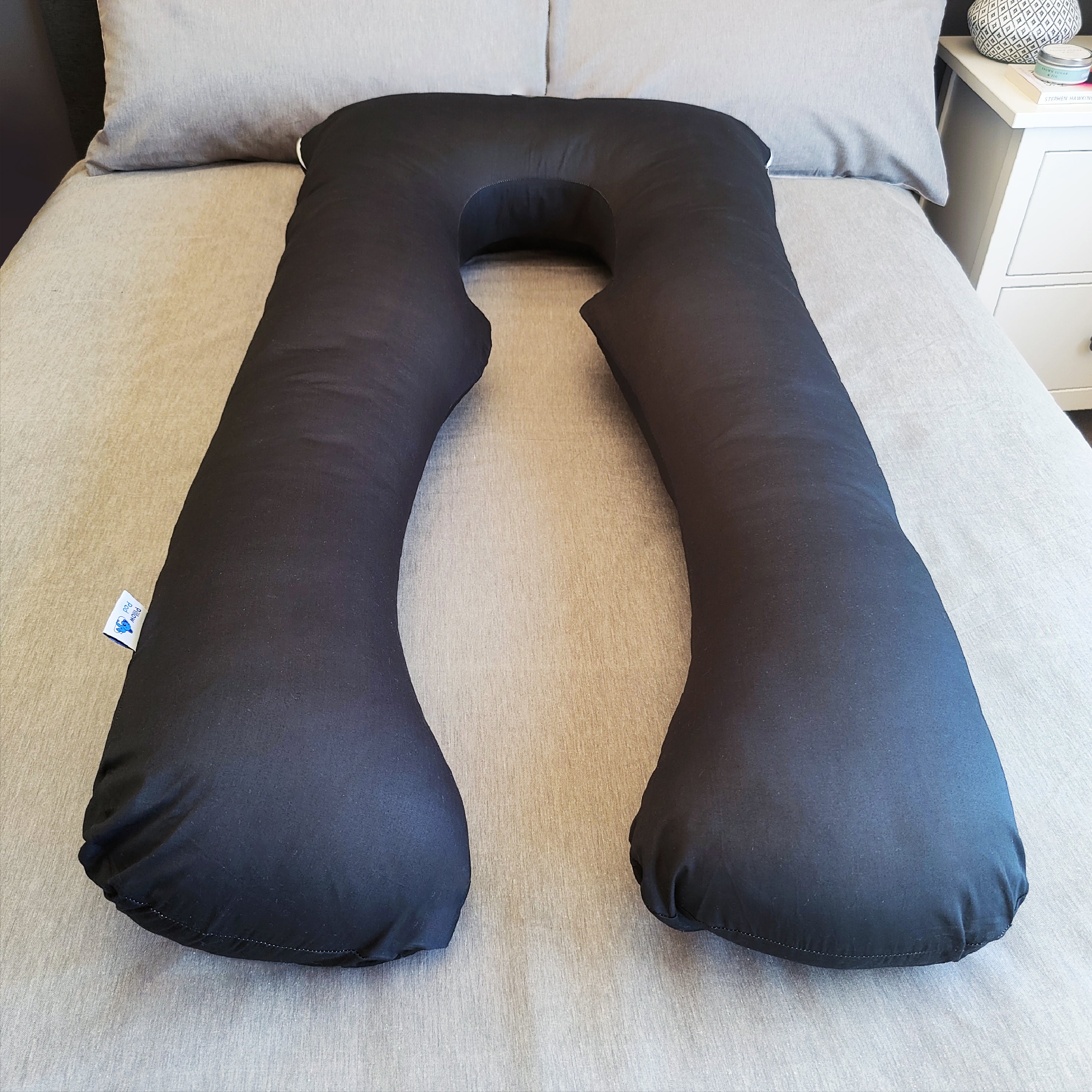 Black Pillow Pod Full Body Support Pillow on Bed, with Plain Grey Bed Spread