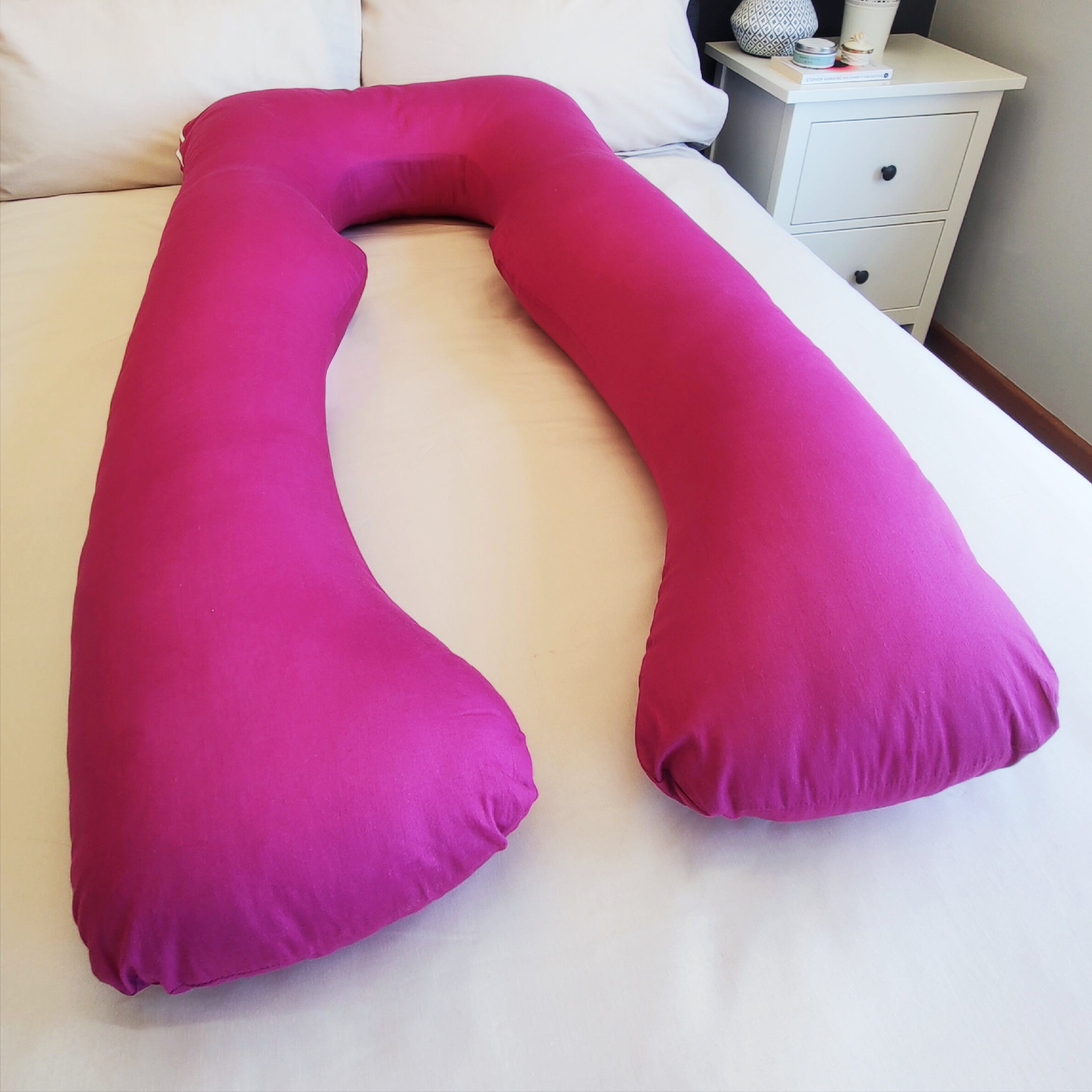 Magenta Pillow Pod Full Body Support Pillow on Bed, with Plain White Bed Spread