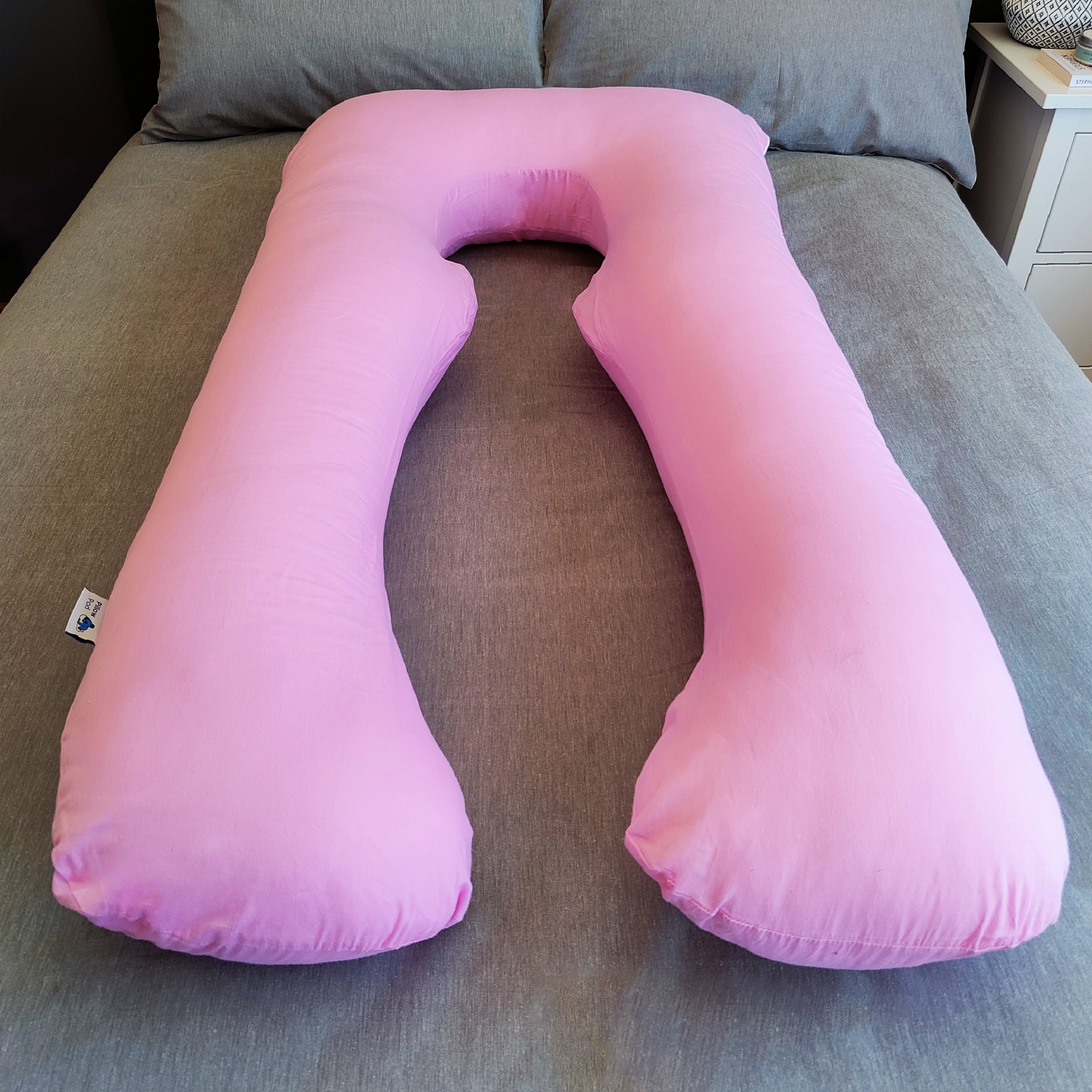 Pink Pillow Pod Full Body Support Pillow on Bed, with Plain Grey Bed Spread